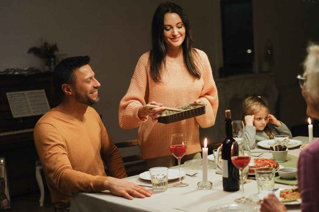 Warm family dinner with candles and wine, perfect for intimate home gatherings.